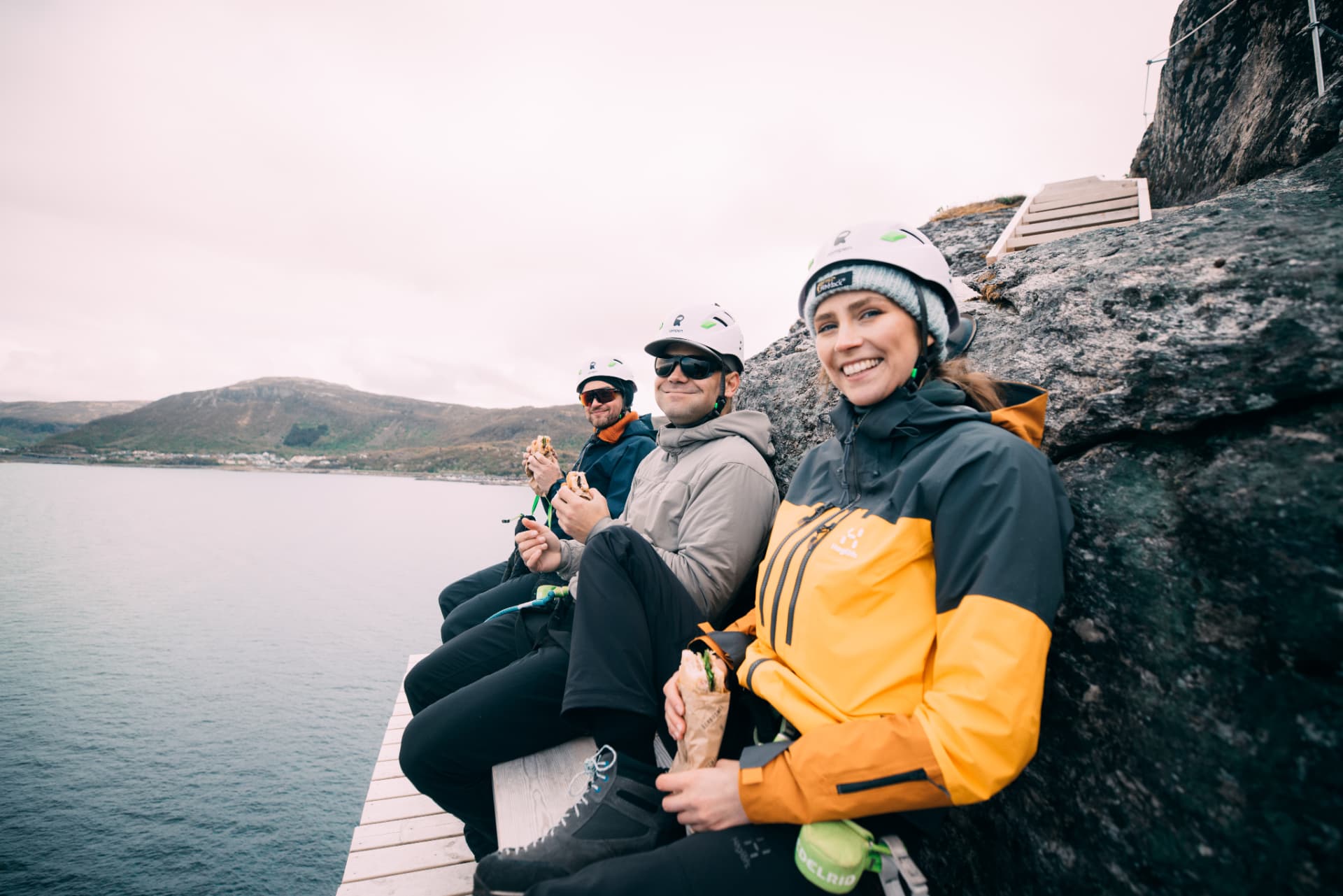 Corporate group taking a break on the Via Ferrata above the sea in Bodø